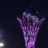 In the night the Baiterek tower is illuminated in constantly changing colors.