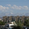 The ugly buildings made with precast concrete slabs from the Soviet Era contrast with the beauty of the high mountains in background.