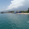 Beach life at Issyk-Kul lake. Despite of its high altitude of 1,607 m the water in the lake has in summer a nice temperature for bathing. Only the many stones on the lake ground are unpleasant for walking on barefoot.