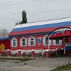 Russian cultural centre in Karakol. The roof of the house and the entrance gate are painted in the national Russian colors.