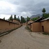 The village Mogien near Panjakent seen from the street is a collection of mudbrick buildings and walls.