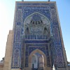 The entrance portal to the Gur-e-Amir ensemble is richly decorated with carved bricks and various mosaics.