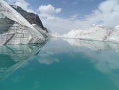 On the huge Engilchek glacier one could explore many meltwater rivers and lakes. The most famous lake is the Merzbacher Lake, often called the "Disappearing Lake" because it drains every year as the ice melts. An ice dam prevents the lake from draining through the majority of the year however when a hole finally melts through the dam the lake drains within three days, creating major flooding downstream.