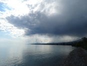 Light effects announce summer thunder storm at the Issyk Kul Lake. Although the lake is surrounded by snow-capped peaks, it never freezes; hence its name, which means "hot lake" in the Kyrgyz language.