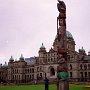 The British Columbia Parliament Building in Victoria, the capital city of the province. The english style architecture contrasts here with the first nations art in form of a totem pole.